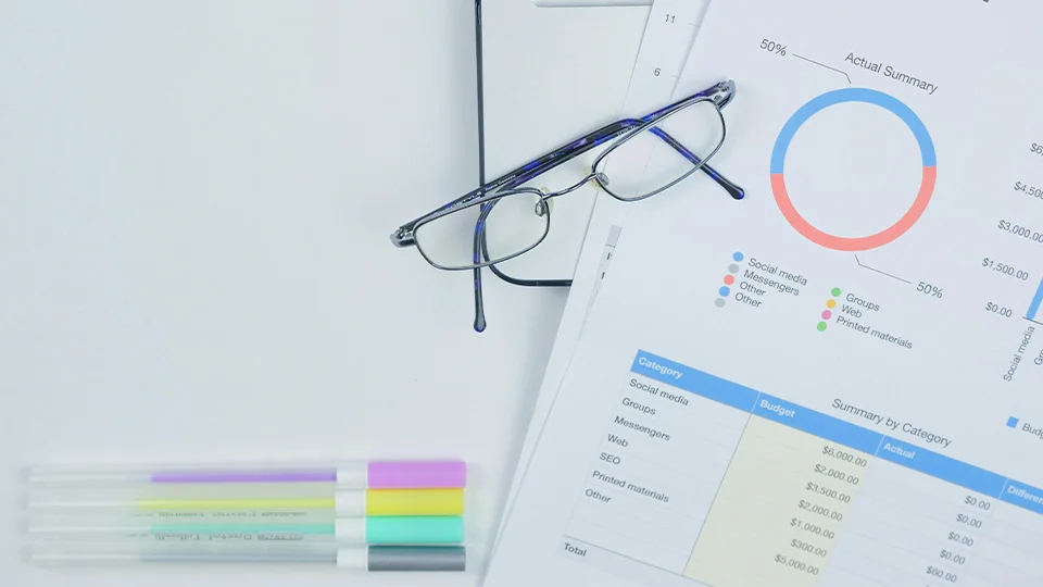 eyeglasses on top of financial statements