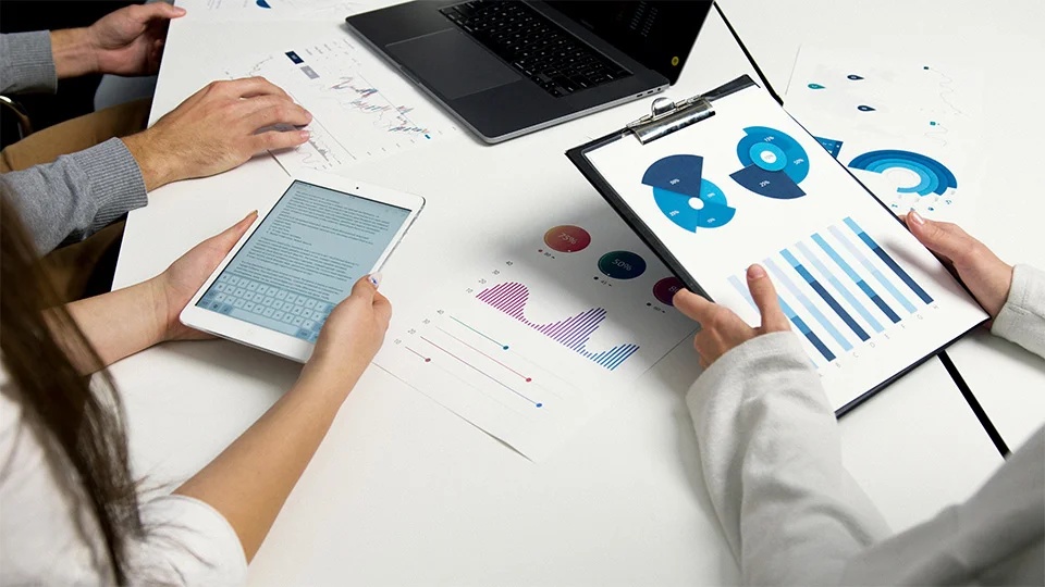Group review profits and finances at a table